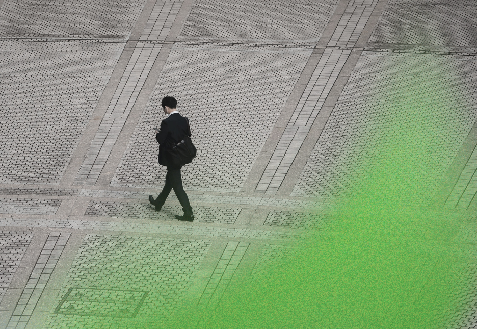 In the distance, a man in a suit is walking down a road where there is no one else